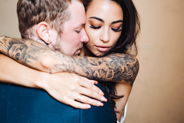 Beautiful, young couple posing on camera indoors - Stock Photo - Images