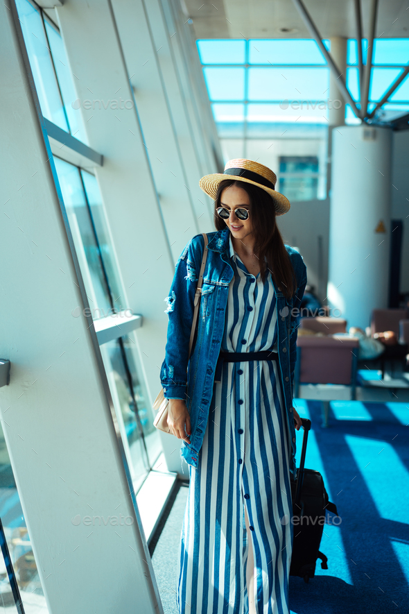 Woman go travel with suit case at airport Stock Photo by simbiothy