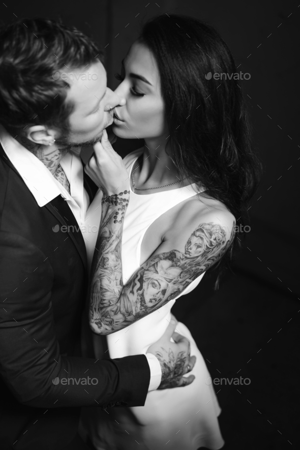 Beautiful, young couple posing on camera indoors - Stock Photo - Images