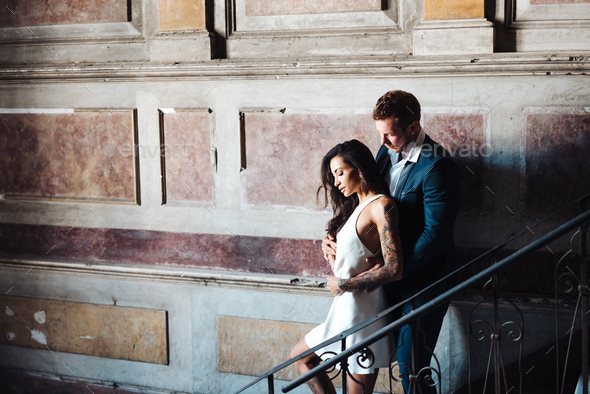 Beautiful, young couple posing on camera indoors - Stock Photo - Images