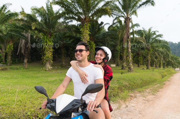 Couple Riding Motorbike, Young Man And Woman Travel On Bike On Tropical Forest Road