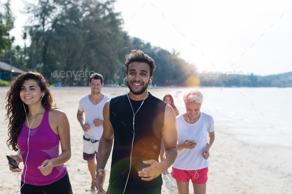 Group Of People Running, Young Sport Runners Jogging On Beach Working Out Smiling Happy, Fit Male