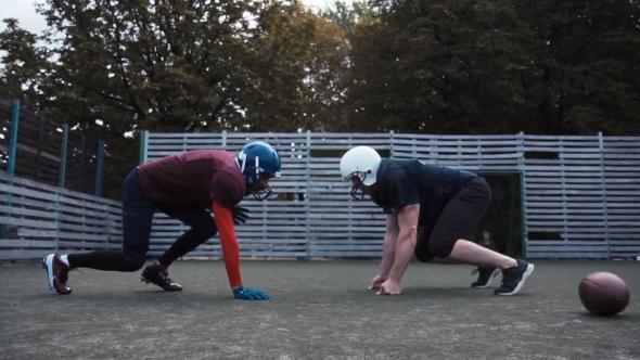 Two Helmeted Football Players alt