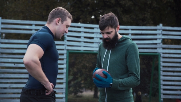 Two Teammates Talking on Field alt