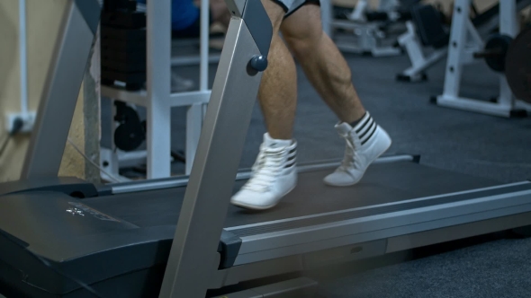 Strong Man in the Gym - Bodybuilder Running on the Running Track in the Gym