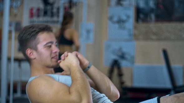 Young Man Doing Sit-ups on Abdominal Bench and Getting Tired Abdominal Exercises