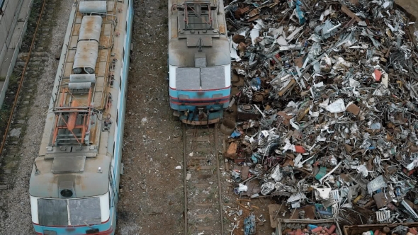 A View From Above of Old and Broken Trams, Next To Them Is a Non-ferrous Metal  alt