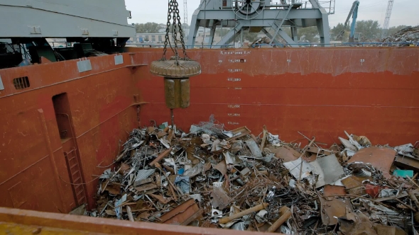 In a Large Container with Metal Debris Fall Iron Parts, a Mechanical Building Magnet Sends the Trash alt