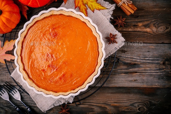 Homemade Pumpkin Pie for Thanksgiving with whipped cream and cinnamon... 