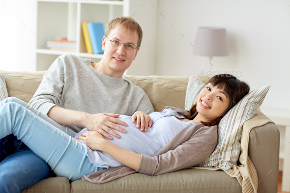 happy pregnant wife with husband at home