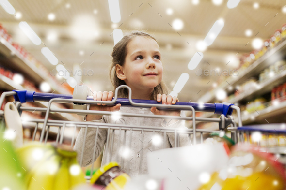 girl with food in shopping cart at grocery store