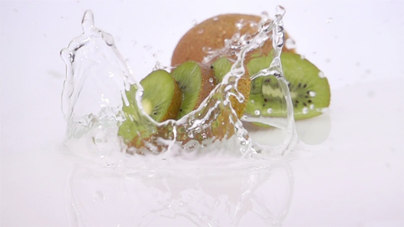 A Several Slices of Kiwi are Falling on the Table.