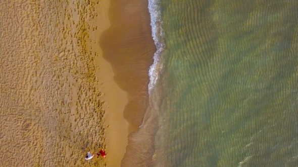 Couple in Love Walking on the Beach Holding Hand in Hand alt