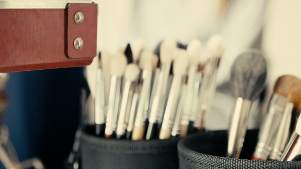 Professional Make-up Artist Applying Cosmetics on a Client in the Salon alt