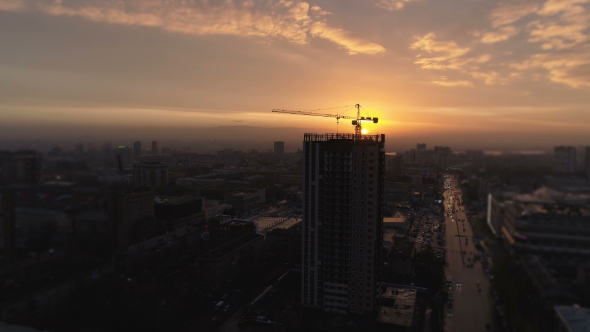 Aerial Bird View of Yellow Tower Building Crane Fly Around Construction Site Building Apartments alt