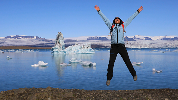 Girl Jumping on The Coast of The Glacial Lake Jokulsarlon