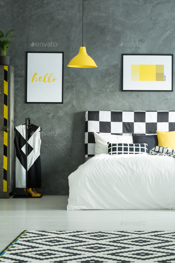 Yellow pillow and blanket on white bedding in simple hotel room Stock Photo  by bialasiewicz