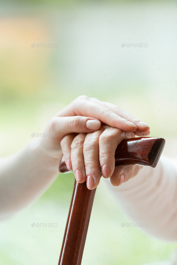 Caregiver's hand on elder's hand - Stock Photo - Images