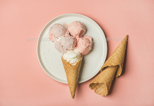 Pink strawberry and coconut ice cream scoops and sweet cones - Stock Photo - Images
