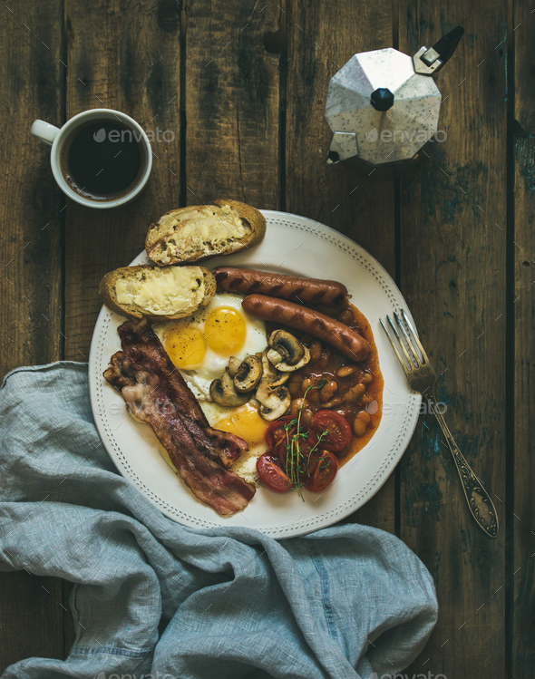 Traditional English breakfast with fried eggs, sausages, mushrooms, bacon - Stock Photo - Images