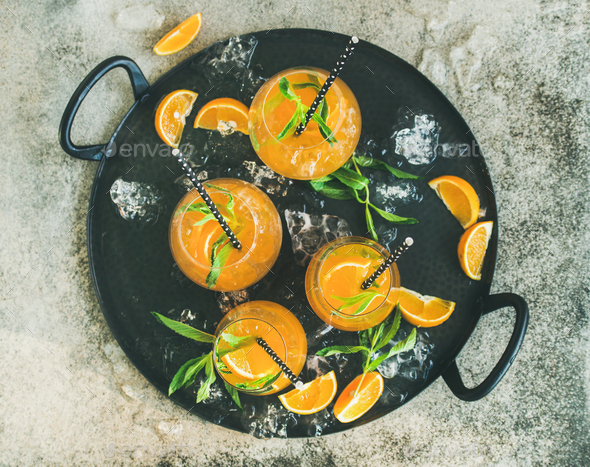 Refreshing alcoholic summer cocktail in glasses on tray, top view - Stock Photo - Images