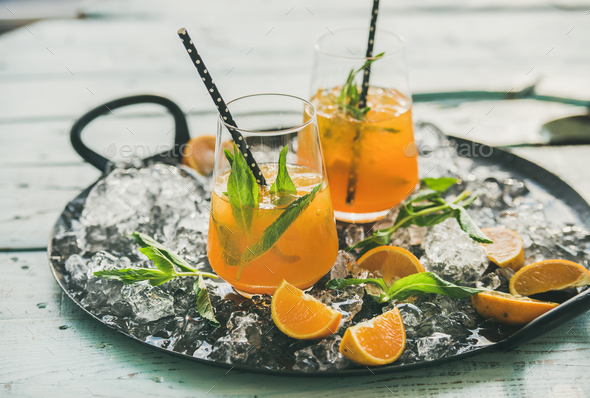 Refreshing cold alcoholic summer cocktail with orange on tray - Stock Photo - Images