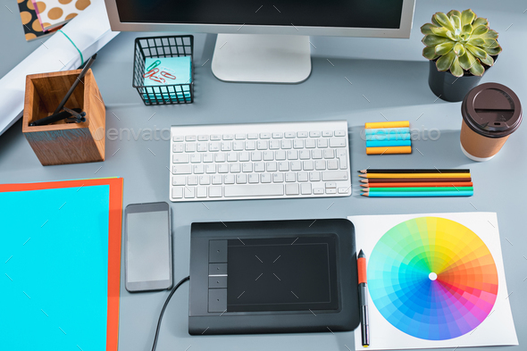The gray desk with laptop, notepad with blank sheet, pot of flower, stylus and tablet for retouching - Stock Photo - Images