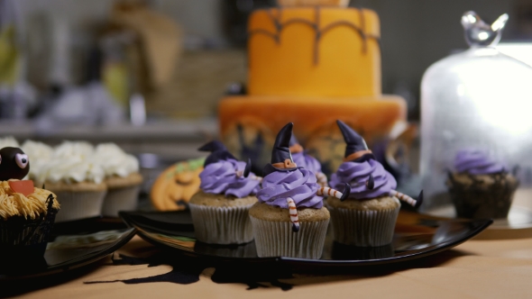 Cupcakes with Icing Hat and Legs. Delicious Muffin Like Witch. Halloween Concept alt