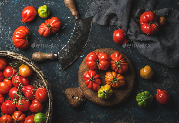 Fresh colorful ripe heirloom tomatoes in basket and wooden board - Stock Photo - Images