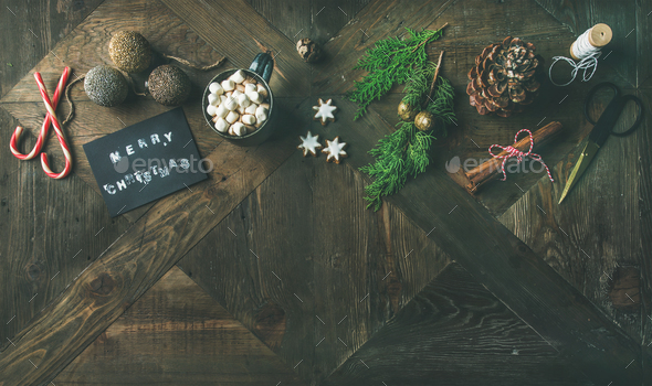 Flat-lay of greeting card, glittering toys, hot chocolate, cinnamon, scissors - Stock Photo - Images