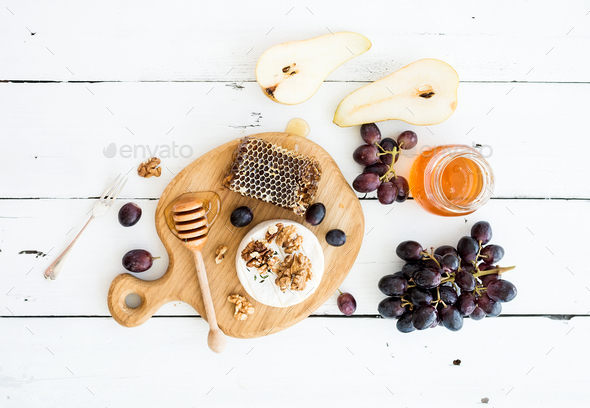 Camembert cheese with grape, walnuts, pear and honey - Stock Photo - Images