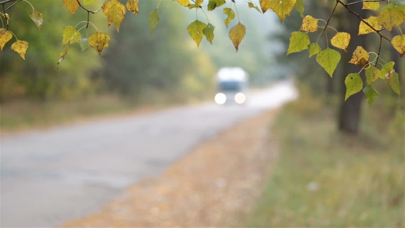 Autumn Landscape. Transport Moves Along the Road.