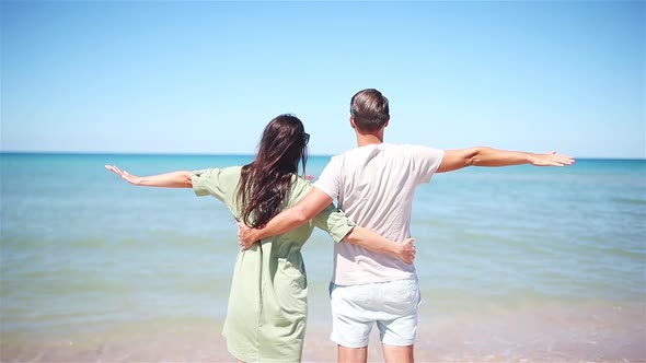 Young Couple on White Beach During Summer Vacation.
