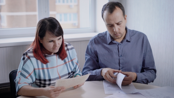 Businesspeople Exploring Important Documents While Gathering on Conference in Office alt
