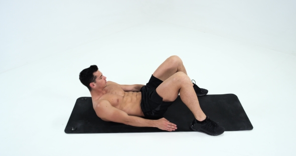 Sport, Bodybuilding, Lifestyle and People Concept - Young Man Making Abdominal Exercises alt