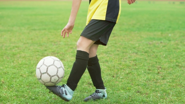 Soccer Player Playing and Juggling with Ball on Field alt