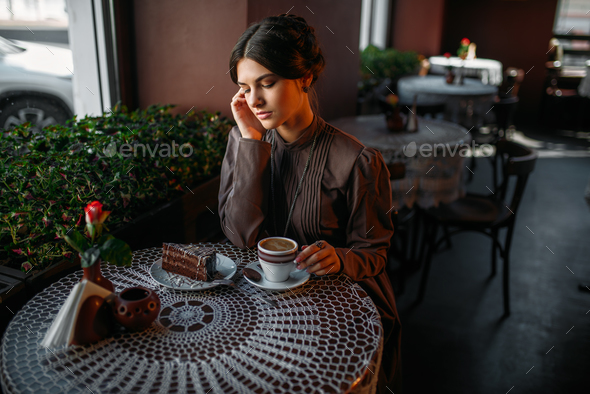 Woman eating delicious chocolate cake in cafe - Stock Photo - Images