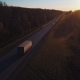 Aerial: the Car with the Container Rides on the Road To the Sunset. Truck Rides the Highway. - VideoHive Item for Sale