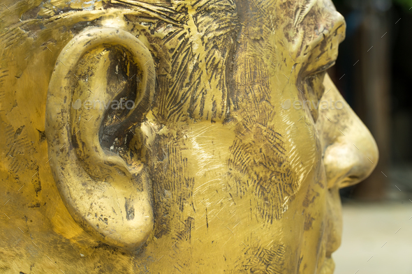 Closeup of unfinished bronze head.