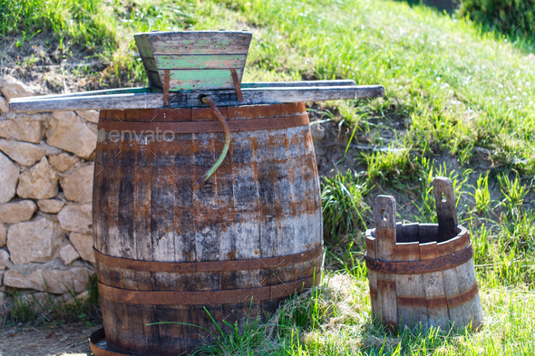 Old rusty wine press with oak barrel.
