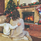 Family near fireplace in decorated house interior - PhotoDune Item for Sale