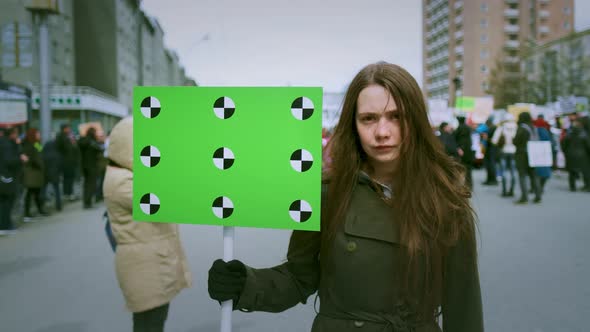 Portrait of Young Girl with an Empty Banner for Your Text Looking at the Camera alt