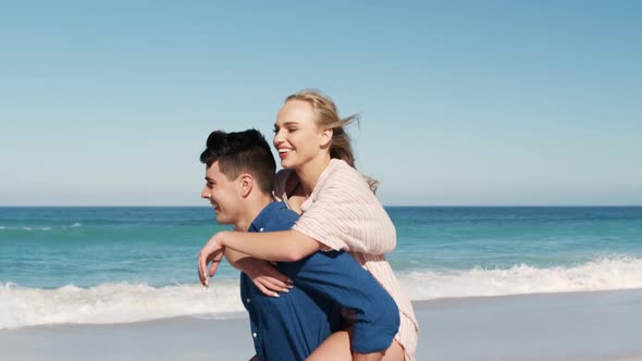 Couple in love enjoying free time on the beach together alt