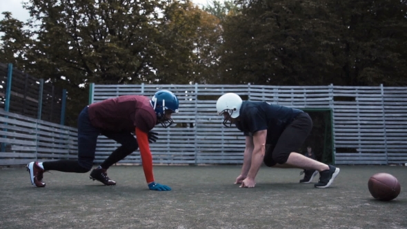 Two Helmeted Football Players alt