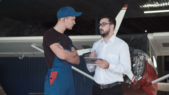 Mechanic and Flight Engineer Having a Discussion alt