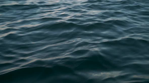 Sea water move while sailing on a small boat in Malta's harbour alt