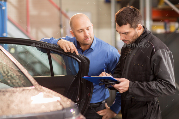 auto mechanic and customer at car shop - Stock Photo - Images