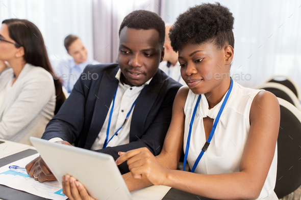 team with tablet pc at business conference - Stock Photo - Images