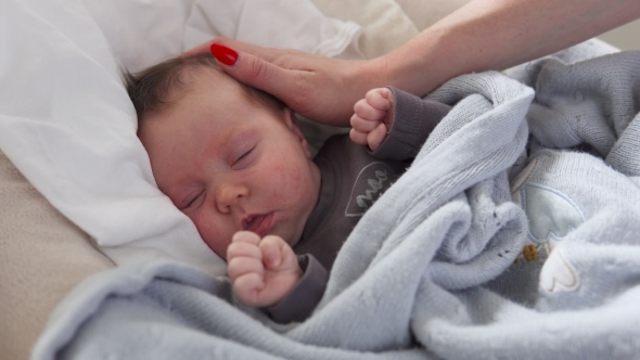 Cute Newborn Baby in Crib