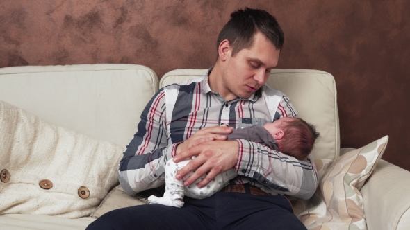 Father Holding a Newborn Baby